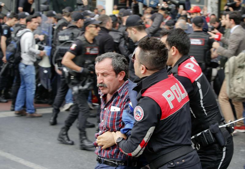 Police officers detain a Turkish man during protests in Istanbul, last May
