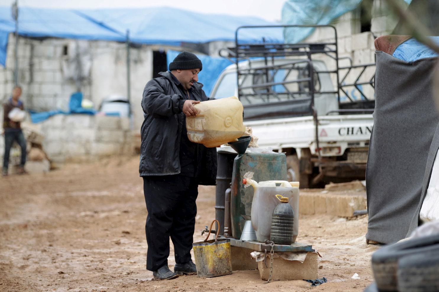 A man fills up fuel near the Turkish border in Idlib province, Syria.