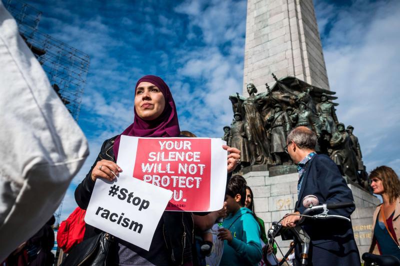 A Muslim woman holds posters as she protests against ‘hate and islamophobia’ in Brussels, last September 9