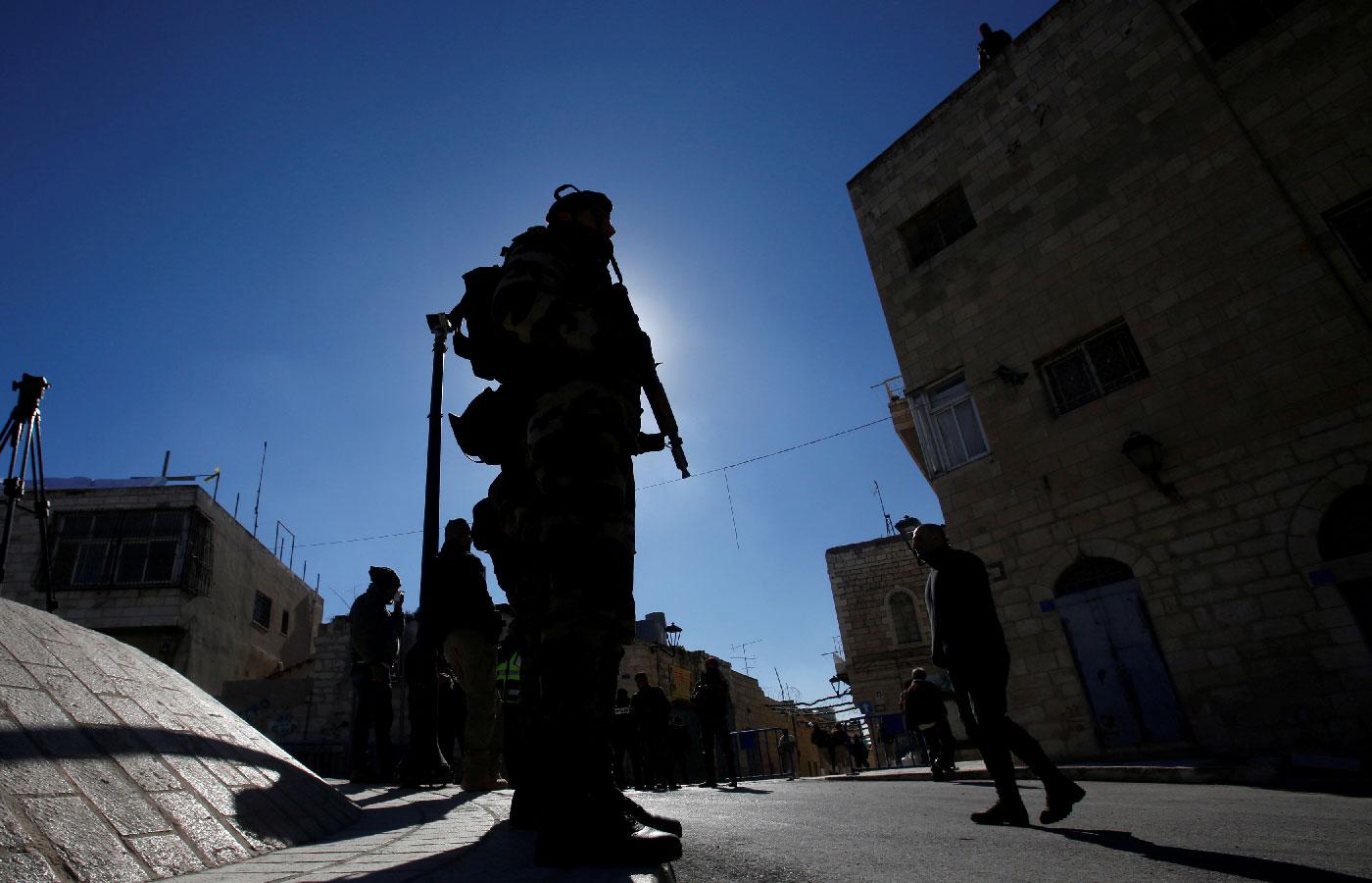 A member of Palestinian security forces stands guard before the arrival of Theophilos III, the Greek Orthodox Patriarch of Jerusalem, in Bethlehem, in the Israeli-occupied West Bank January 6, 2019. 