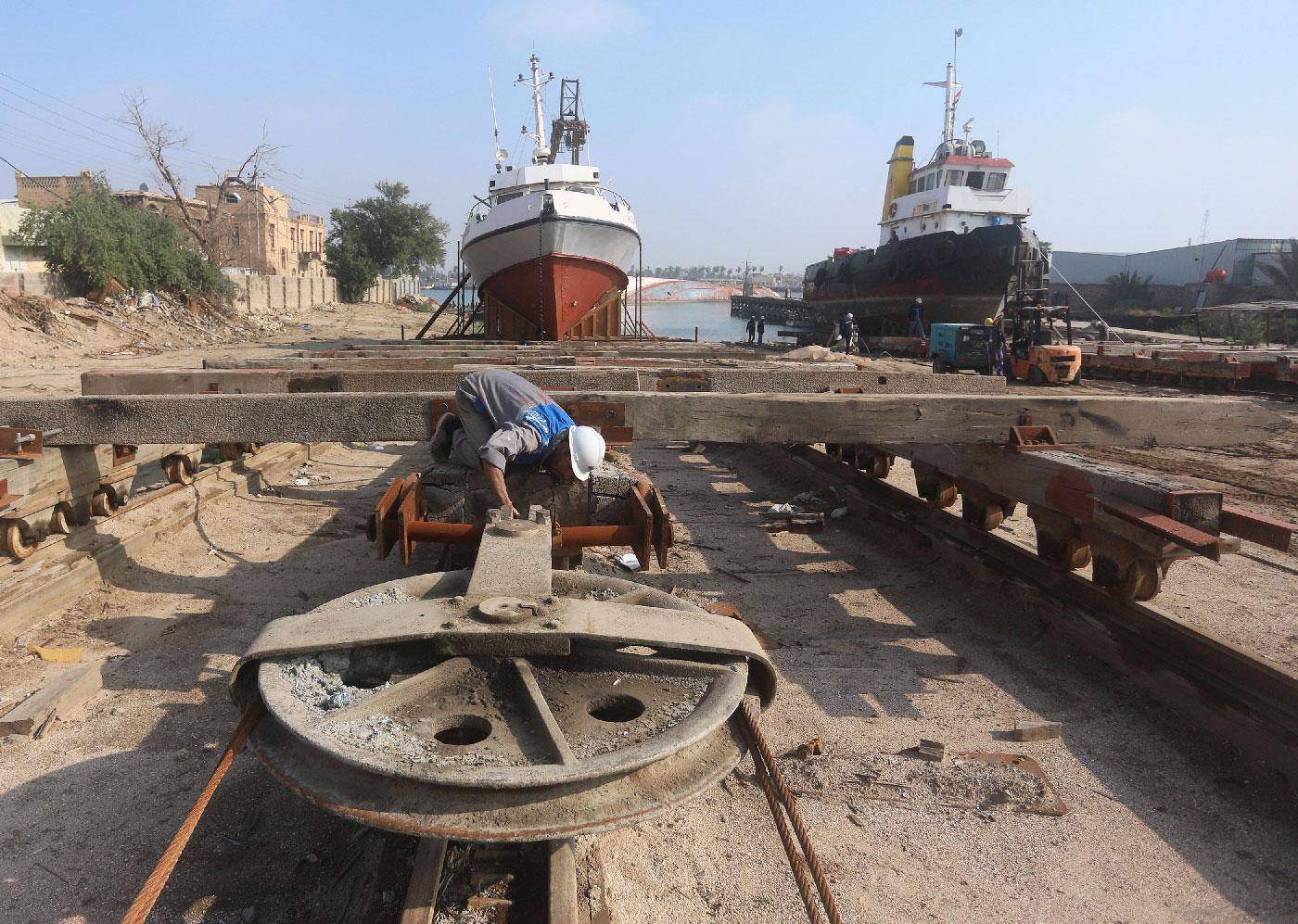 A worker inspects a pulley that pulls ships at a shipyard built by the British Army on Basra's docks in 1918, in Basra, Iraq December 23, 2018.