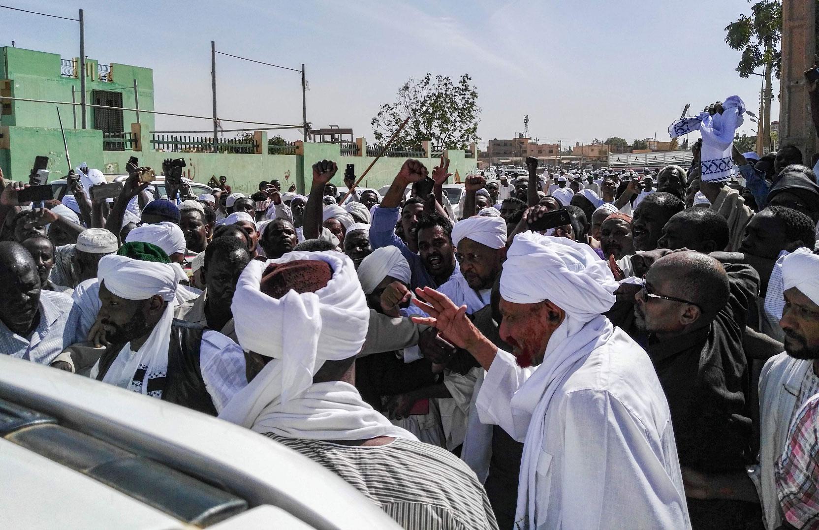 Sadiq al-Mahdi (2nd-R), Sudan's ex-prime minister and leader of the opposition Umma Party, is surrounded by supporters as he exits a mosque during a demonstration in the capital Khartoum's twin city of Omdurman on January 25, 2019.