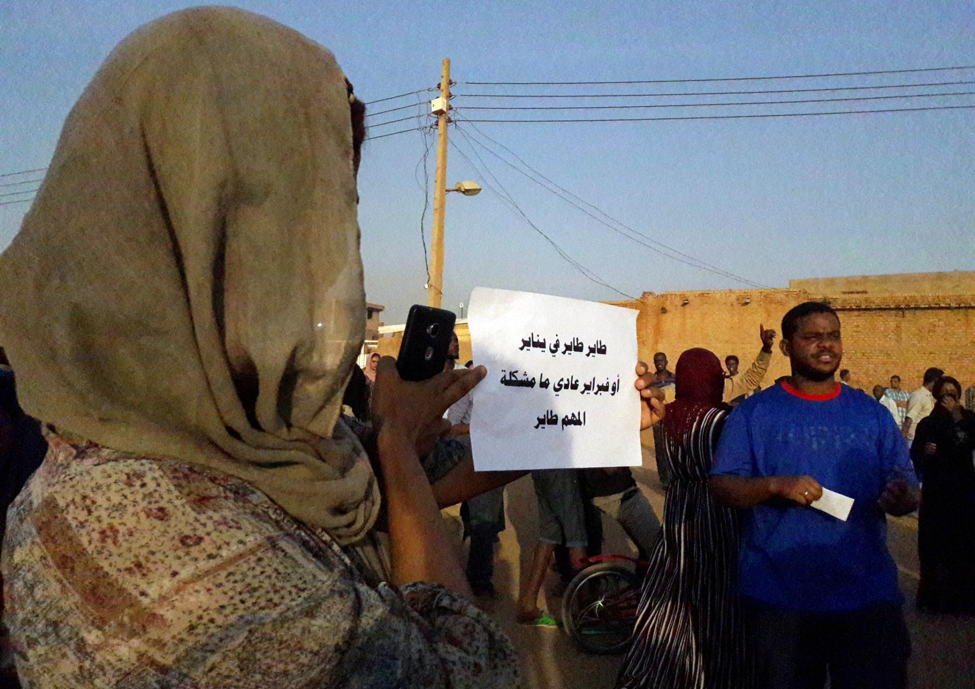 A Sudanese demonstrator carries a placard which reads in Arabic "You will leave in January, or February, no problem, as long as you are leaving," as he attends a sit-in on January 27, 2019, in the Bahri neighbourhood, north of the capital Khartoum.