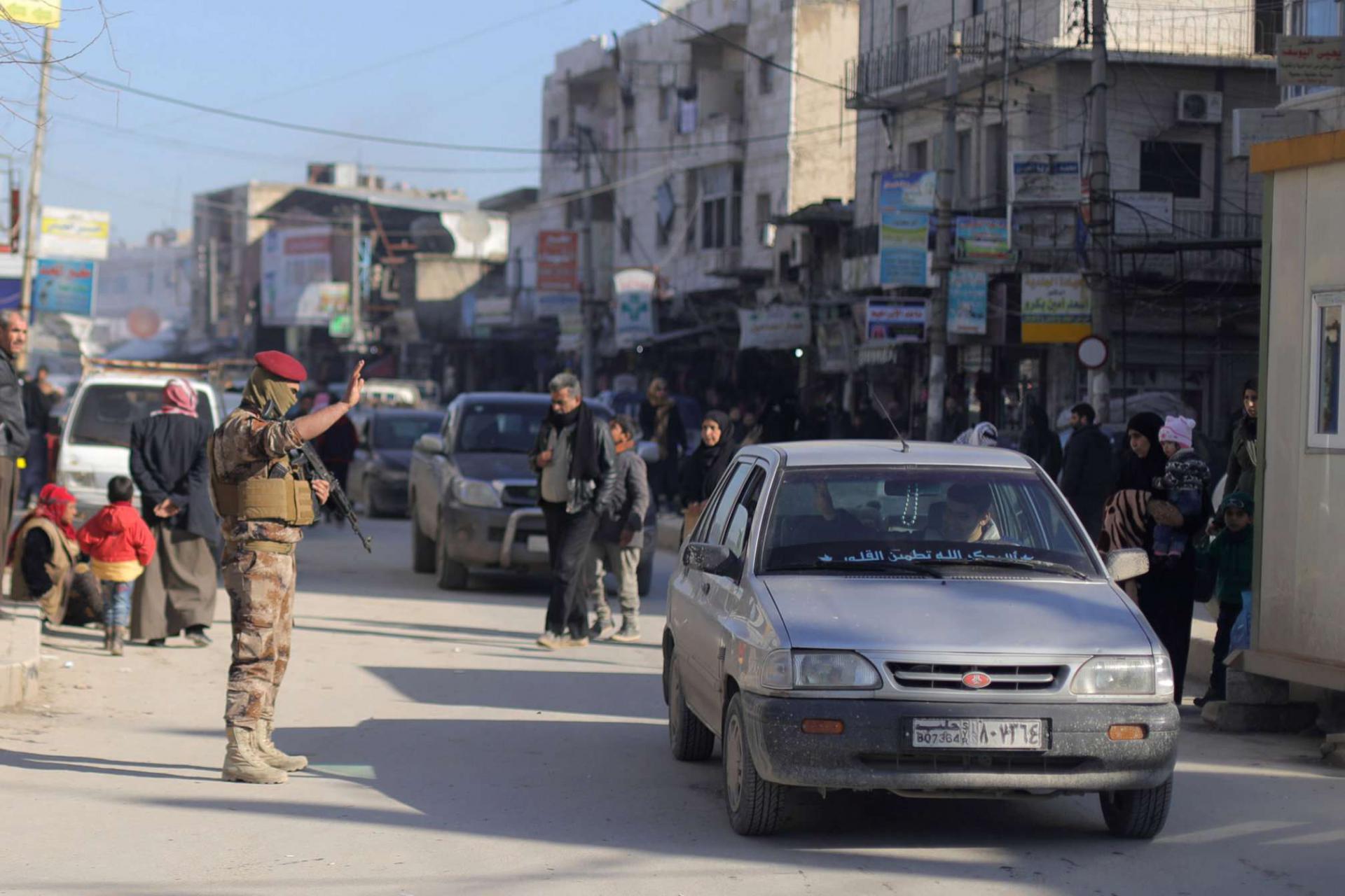 A member of Manbij Military Council gestures at a car in Manbij city, Syria December 29, 2018.