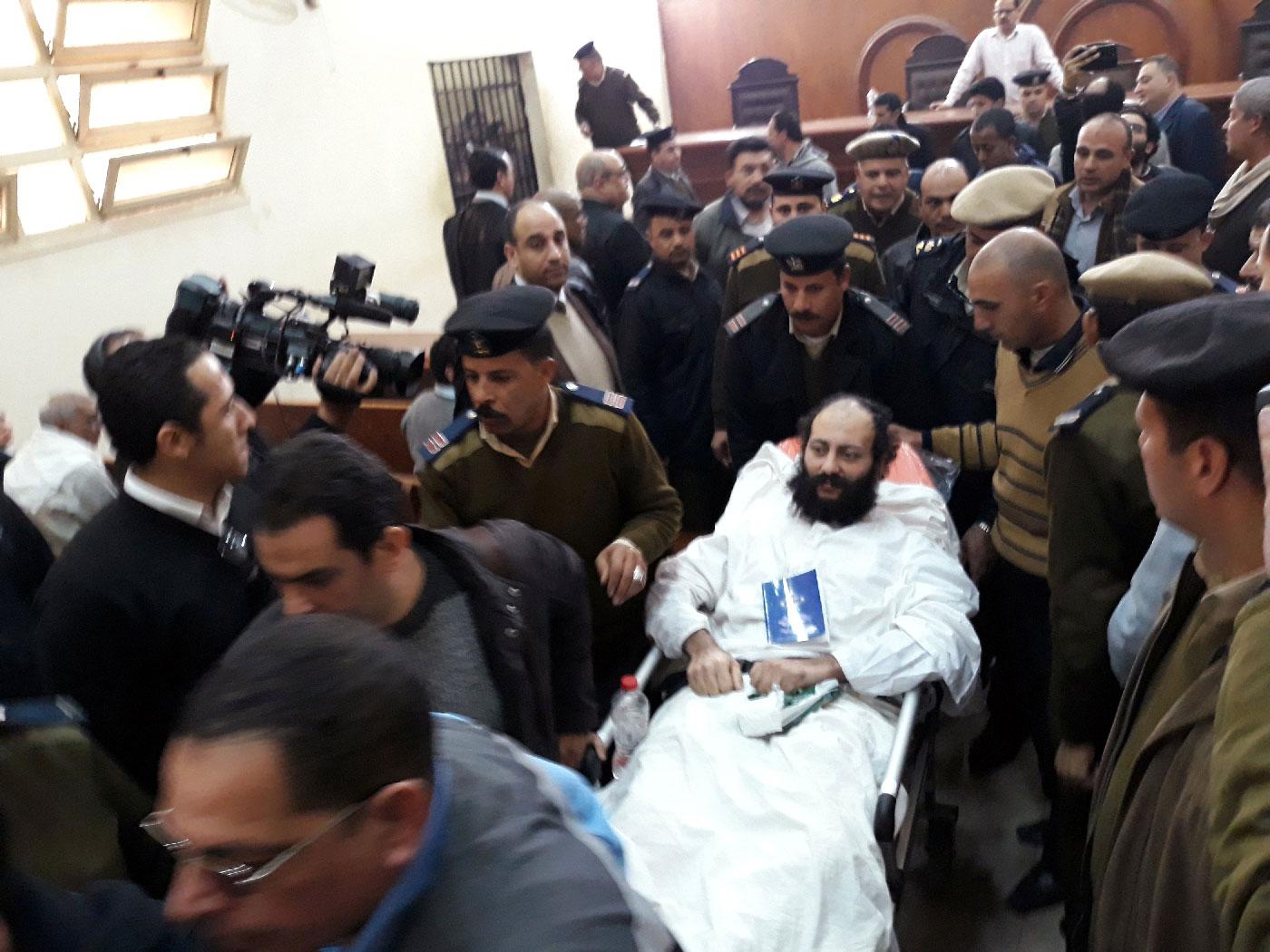 Ramon Rasmi Mansour, known as Faltaous al-Makari, lies on a stretcher after his and monk Isaiah's (not seen) trial session, at the courthouse in a courtroom where he was convicted along with Wael Saad, known as Isaiah al-Makari, of murdering Bishop Epiphanius, the abbot of Saint Macarius Monastery northwest of Cairo, in Damanhour, Egypt February 23, 2019.
