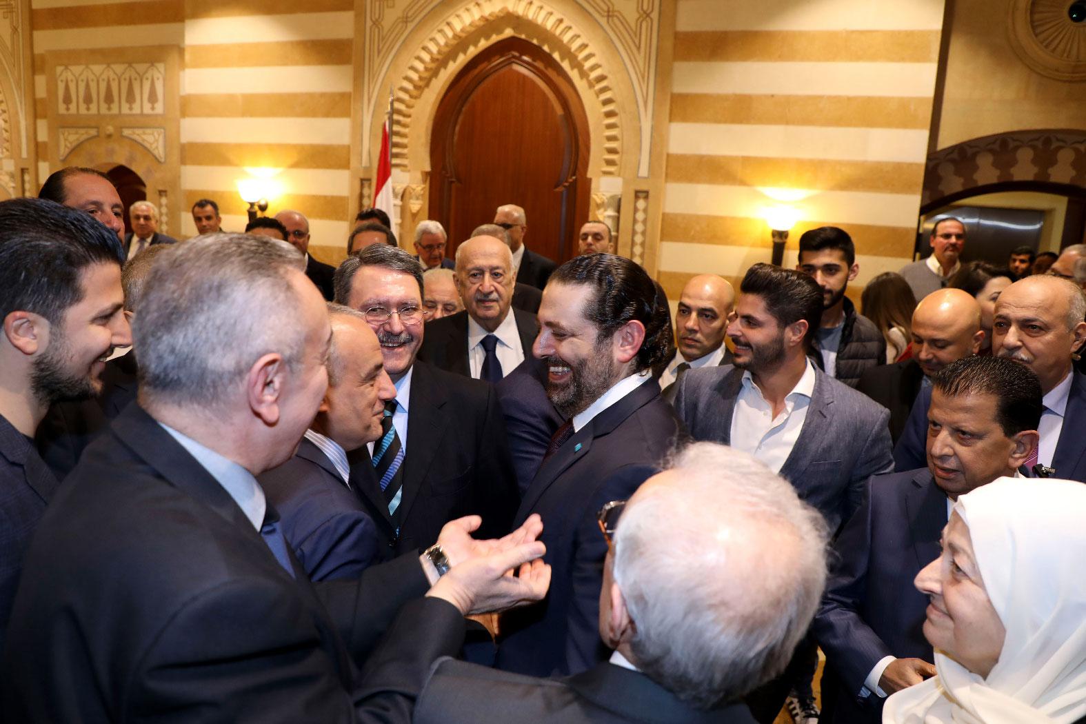 Lebanese Prime Minister Saad Hariri (C) stands amongst supporters after a press conference during which he announced the formation of a new national unity government following months of wrangling between rival groups, at Baabda Palace.