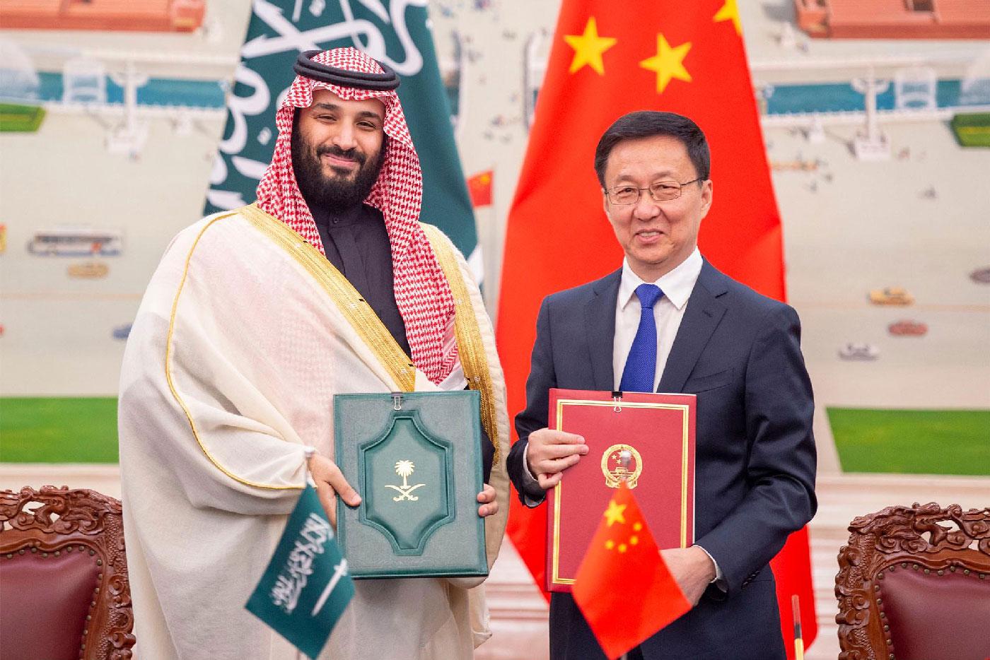Saudi Crown Prince Mohammed bin Salman bin Abdulaziz Al Saud (L) and Han Zheng, Vice-Premier of the State Council of the People's Republic of China, pose for pictures during after the signing of memorandums of understanding at the Great Hall of the People in Beijing, China on 22 February 2019 . 