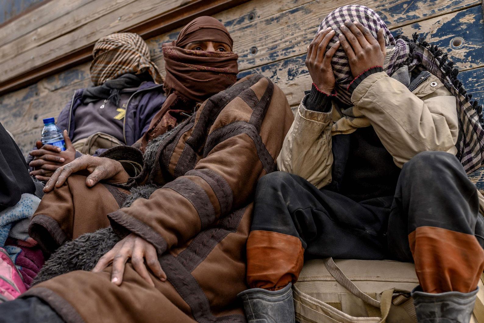 Men suspected of being Islamic State (IS) wait to be searched by members of the Kurdish-led Syrian Democratic Forces (SDF) after leaving the IS group's last holdout of Baghouz, in Syria's northern Deir Ezzor province on February 27, 2019.