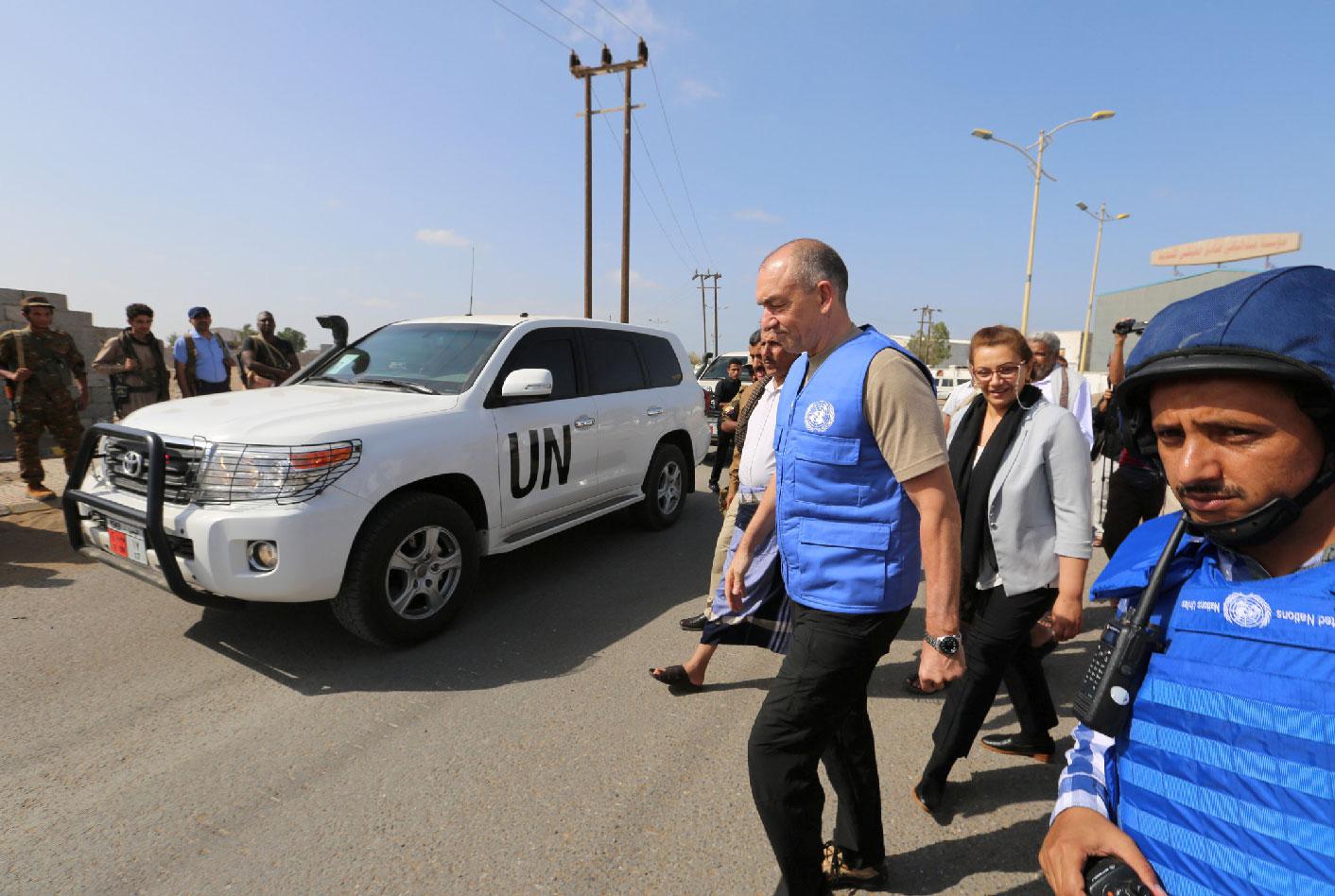 Danish Major General Michael Lollesgaard, who heads a U.N. team tasked with monitoring a ceasefire between Houthis and Yemeni government forces, walks by a convoy of a U.N. and WFP team crossing from Houthi-controlled areas to a government-controlled areas to reach grain mills in an eastern suburb of Hodeidah, Yemen February 26, 2019.
