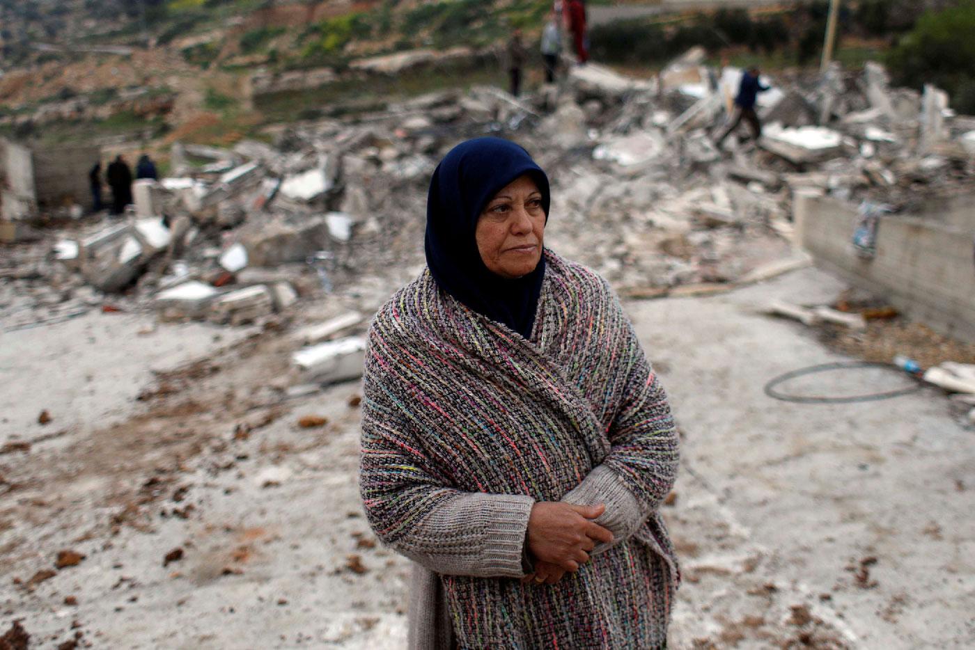 The mother of Palestinian assailant Asem Al-Barghouti looks on as she stands near the remains of his house after it was demolished by Israeli forces, in the village of Kobar near Ramallah, in the Israeli-occupied West Bank, March 7, 2019.