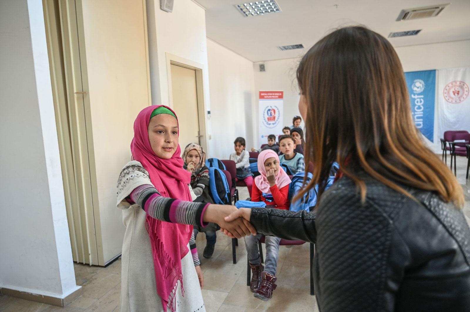 A teacher gives Turkish language lessons to Syrian children at Turkish Youth and Sport Center (Genclik ve Spor Merkezi) in Adana on March 18, 2019.