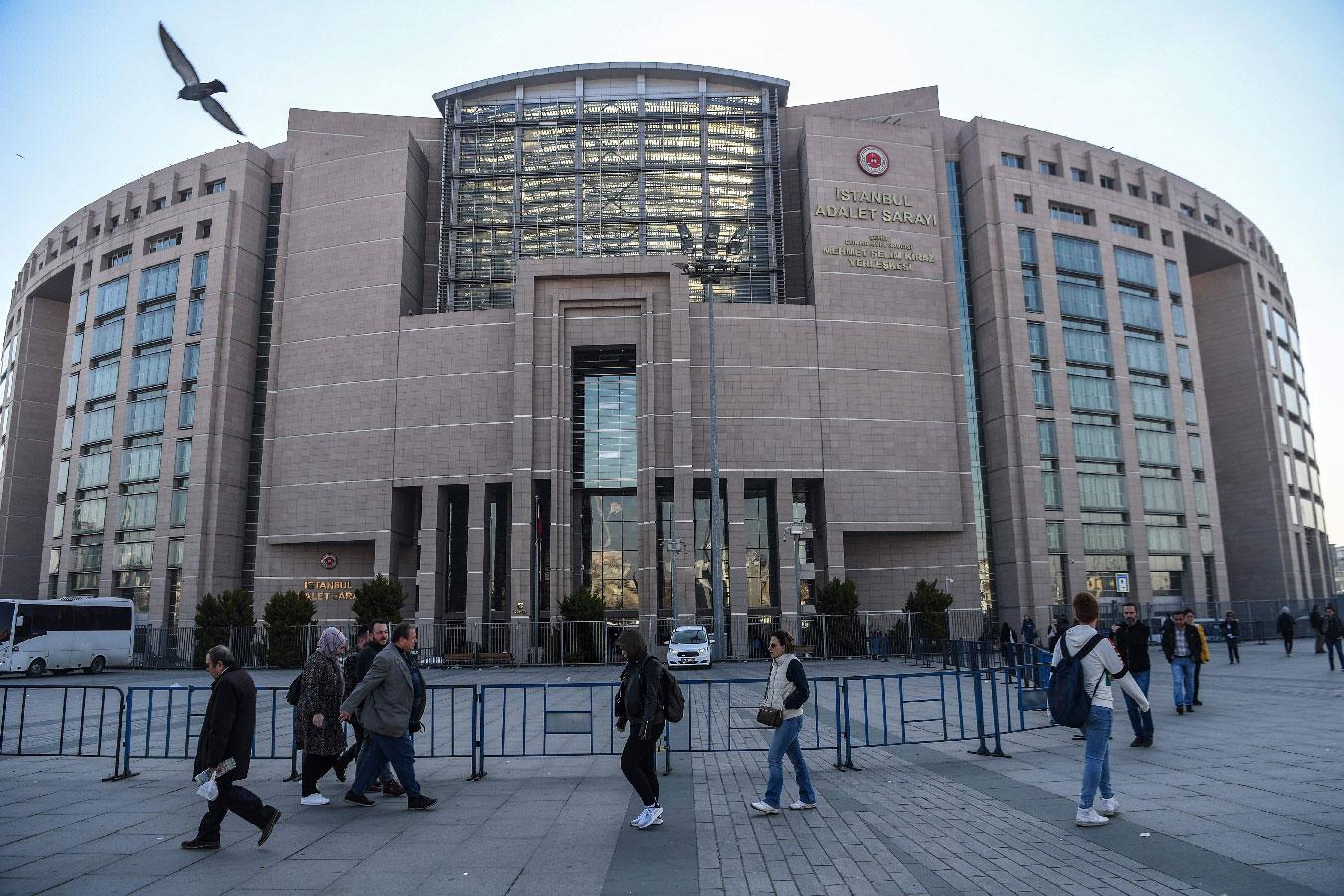 People walk by Istanbul's courthouse on March 26, 2019, during the trial of a US consulate staffer accused of spying and attempting to overthrow the government.