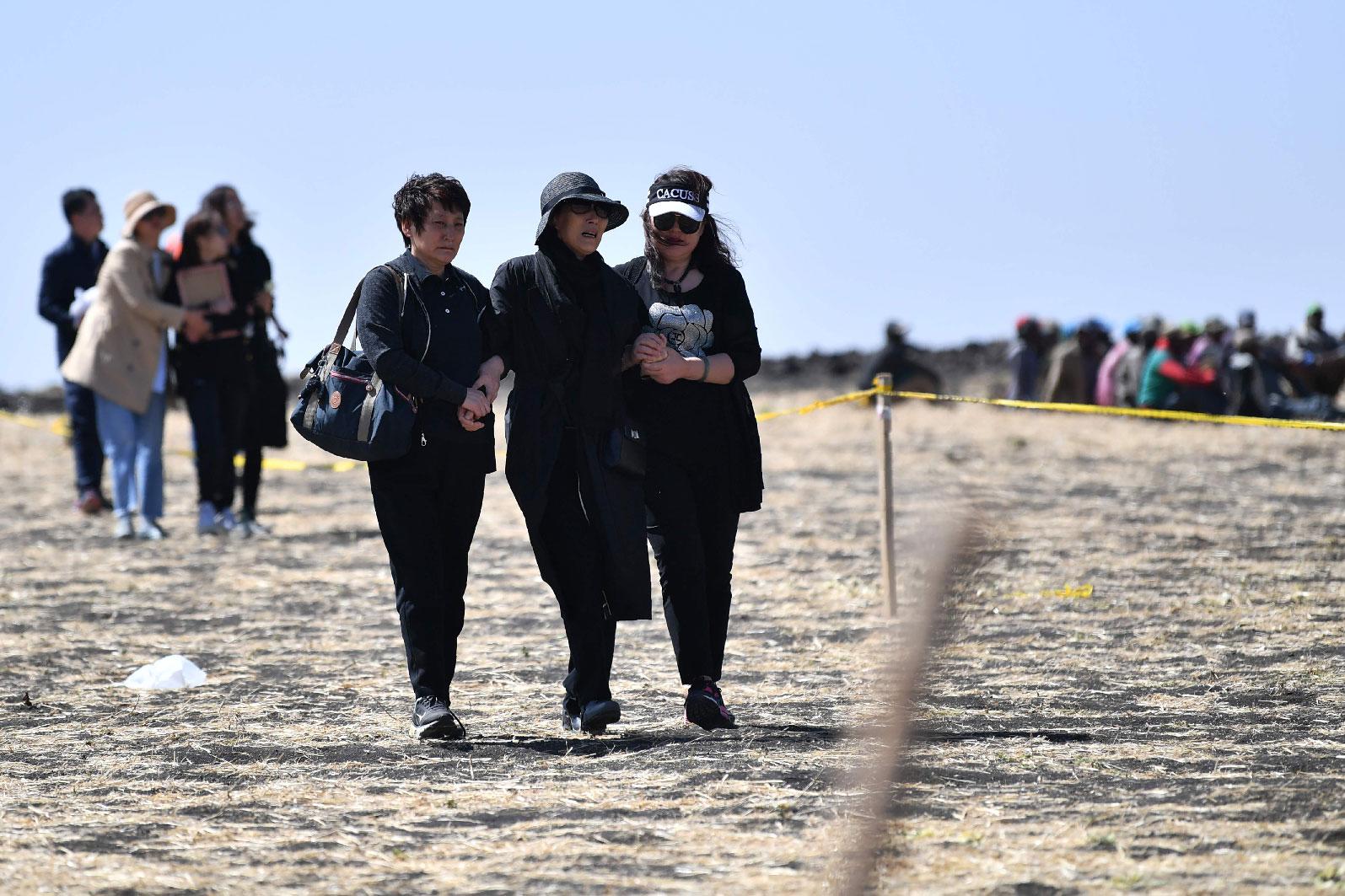 A family member of victims from China walk toward the crash site of the Ethiopian Airlines operated Boeing 737 MAX aircraft in which their relatives perished among the 157 passengers and crew onboard, at Hama Quntushele village, near Bishoftu, in Oromia region, on March 15, 2019.