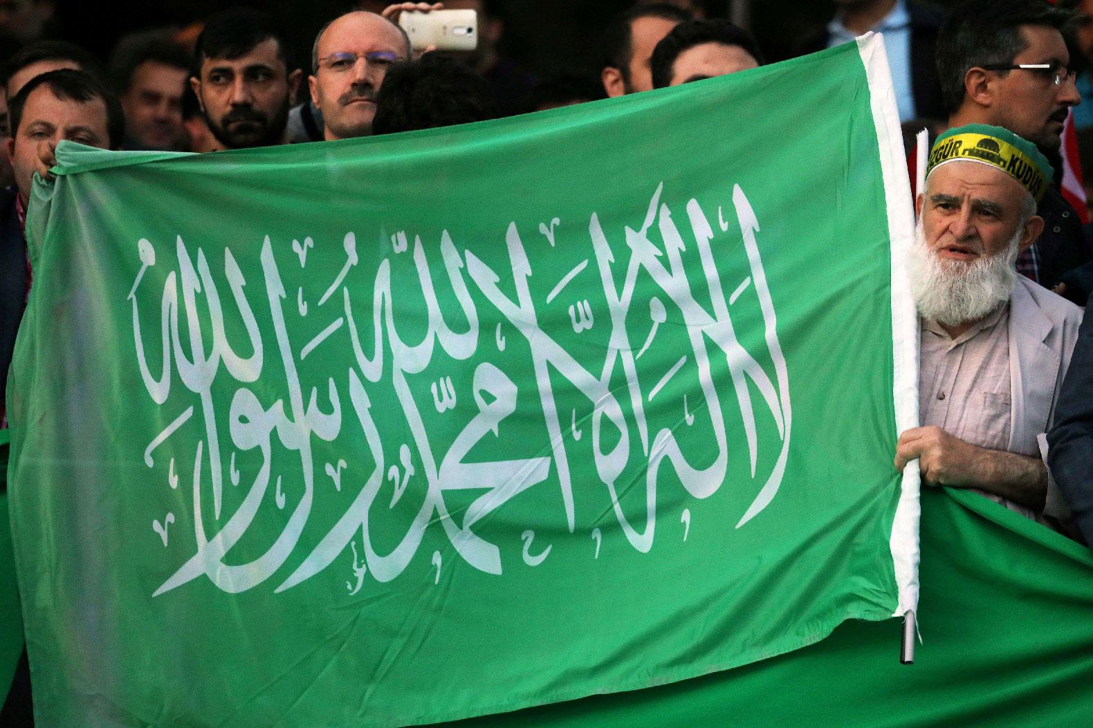A protester chants slogans as he holds a Hamas flag outside the residence of the Israeli Ambassador in Ankara on May 14, 2018 during a demonstration against US President Donald Trump's decision to move the US embassy from Tel Aviv to Jerusalem.