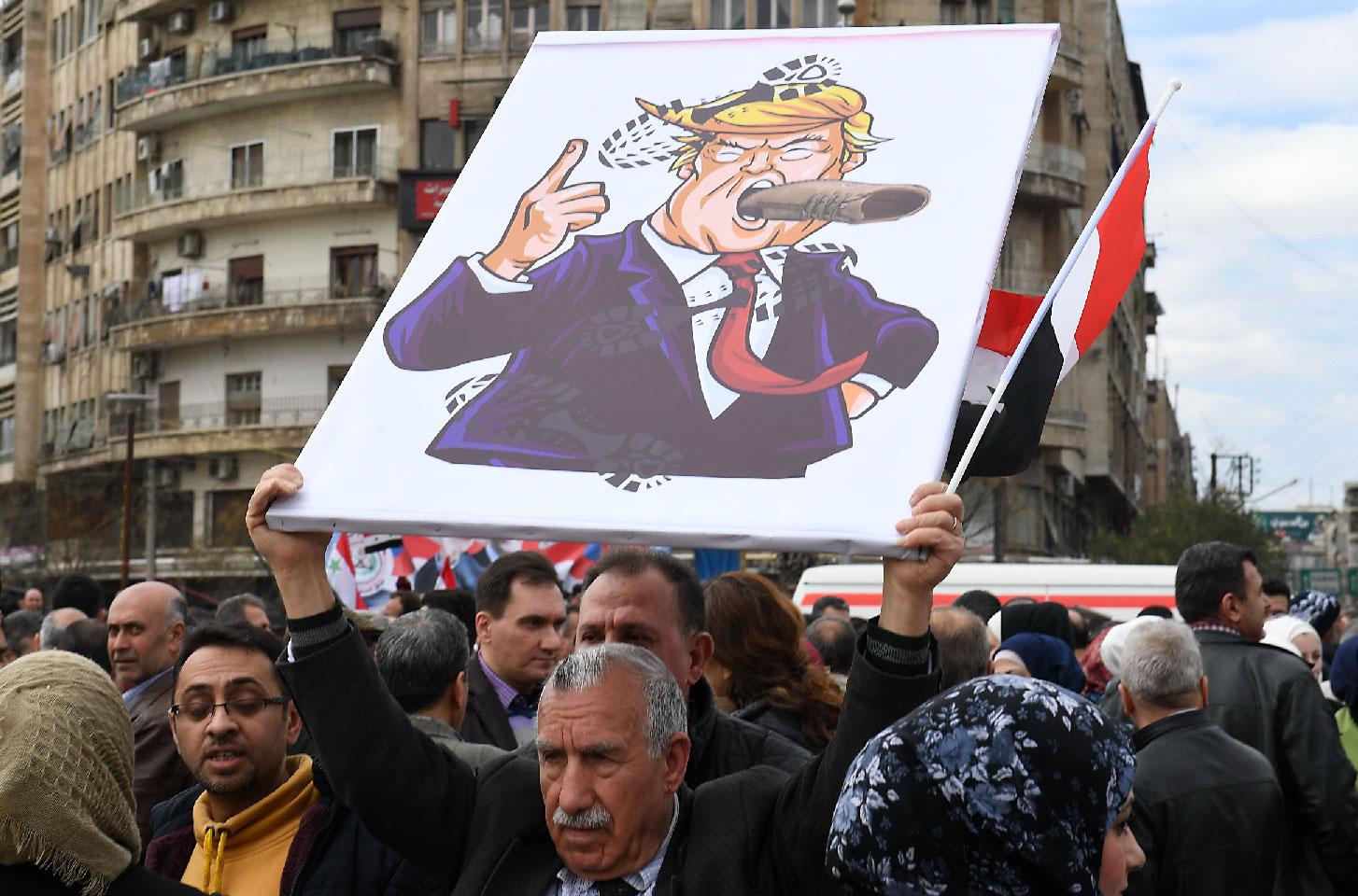 Syrians protest in the northern city of Aleppo against the US' decision to recognise Israel's sovereignty over the Golan Heights on March 26, 2019.