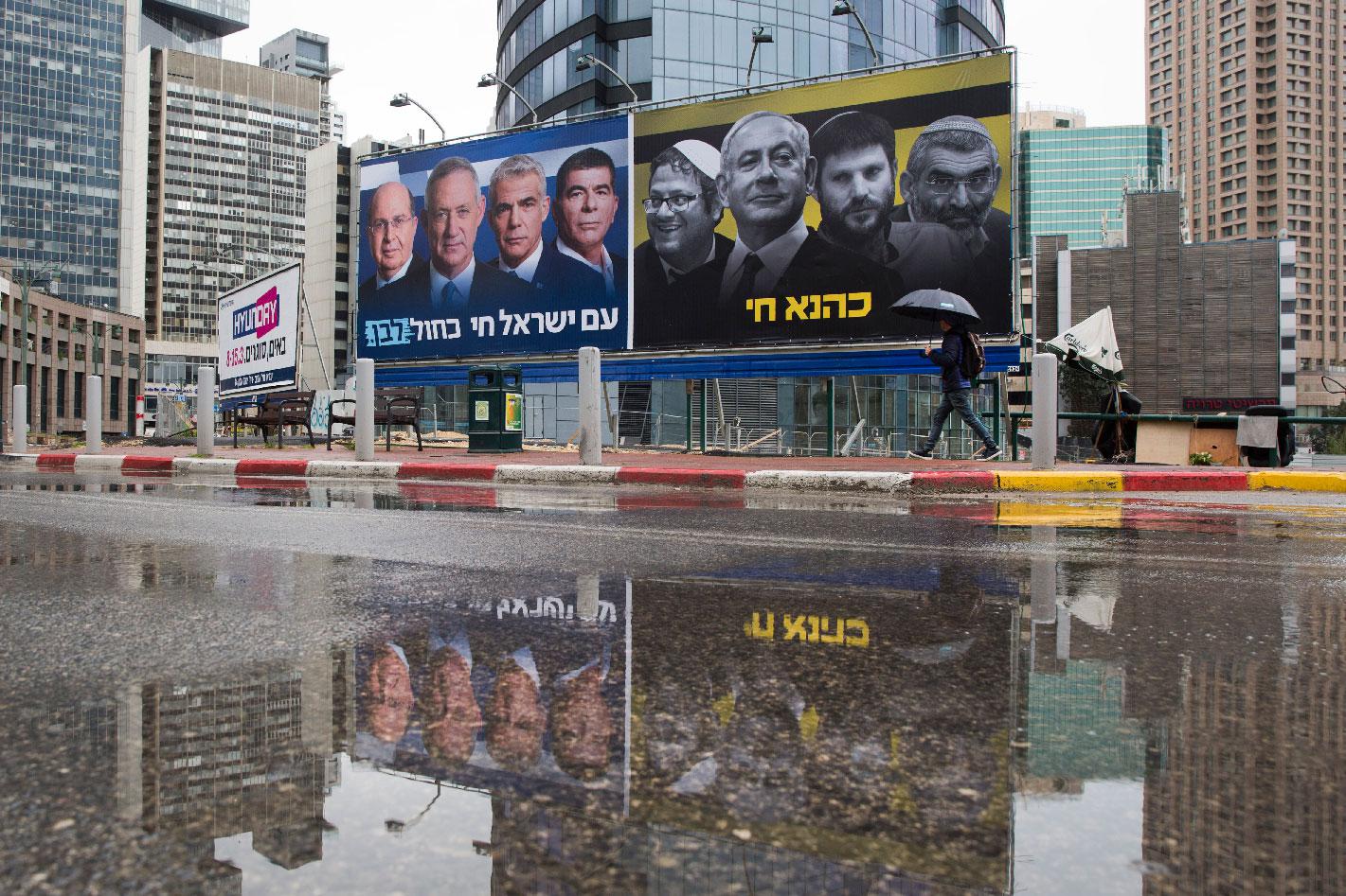 Elections billboards of the Blue and White party leaders, from left to right, Moshe Yaalon, Benny Gantz, Yair Lapid and Gabi Ashkenazi, alongside a panel on the right showing Prime Minister Benjamin Netanyahu flanked by extreme right politicians, from the left, Itamar Ben Gvir, Bezalel Smotrich and Michael Ben Ari in Ramat Gan, Israel, Saturday, March 16, 2019.