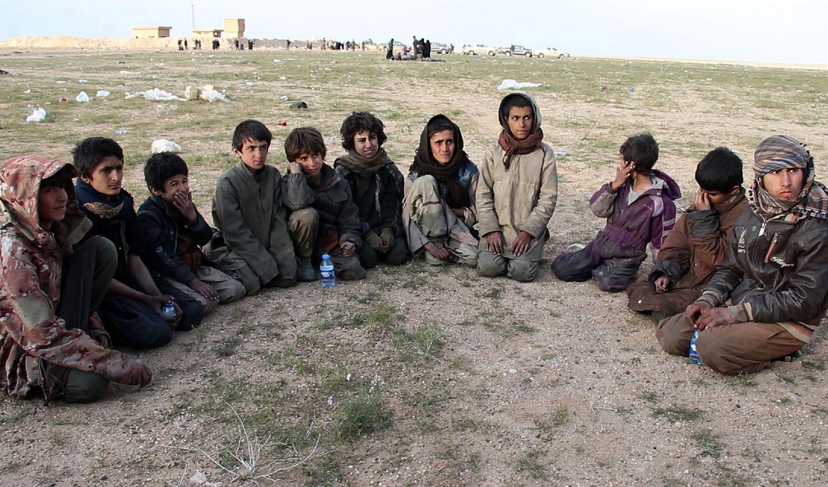 Saddam, (R) a 15 year old Yazidi boy and ten other Yazidi children gather in a area held by the US-backed Kurdish-led Syrian Democratic Forces (SDF), in the eastern Syrian province of Deir Ezzor, after fleeing the Islamic State (IS) group's embattled holdout of Baghouz, on February 23, 2019.Saddam, (R) a 15 year old Yezidi boy and ten other Yezidi children gather in a area held by the US-backed Kurdish-led Syrian Democratic Forces (SDF), in the eastern Syrian province of Deir Ezzor, after fleeing the Islami