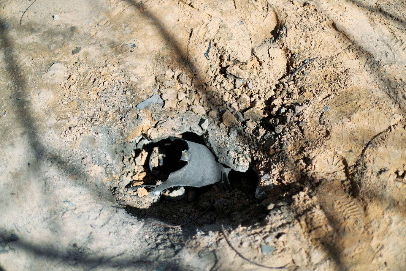 A hole made by an exploded missile is seen in Abu Salim district in Tripoli, Libya