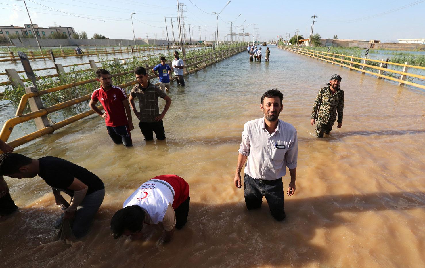 Barricades are set up to contain water in a flooded street in the city of Ahvaz, the capital of Iran's Khuzestan province