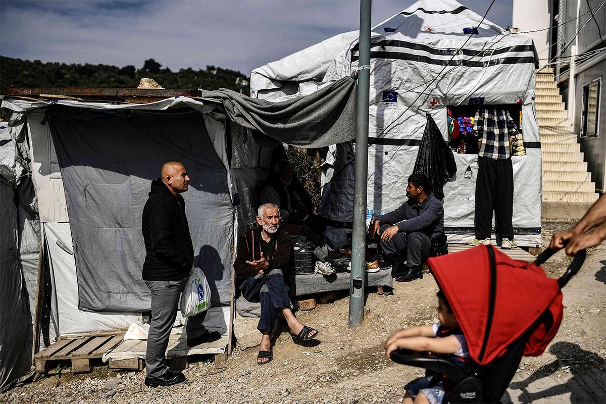 An elderly man sits inside the official refugee camp of Moria on Lesbos Island