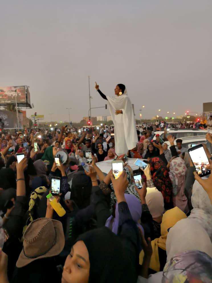 A Sudanese woman gestures during a protest demanding Sudanese President Omar Al-Bashir to step down along a bridge in Khartoum, Sudan April 8, 2019, in this still image taken from a social media video obtained on April 9, 2019.