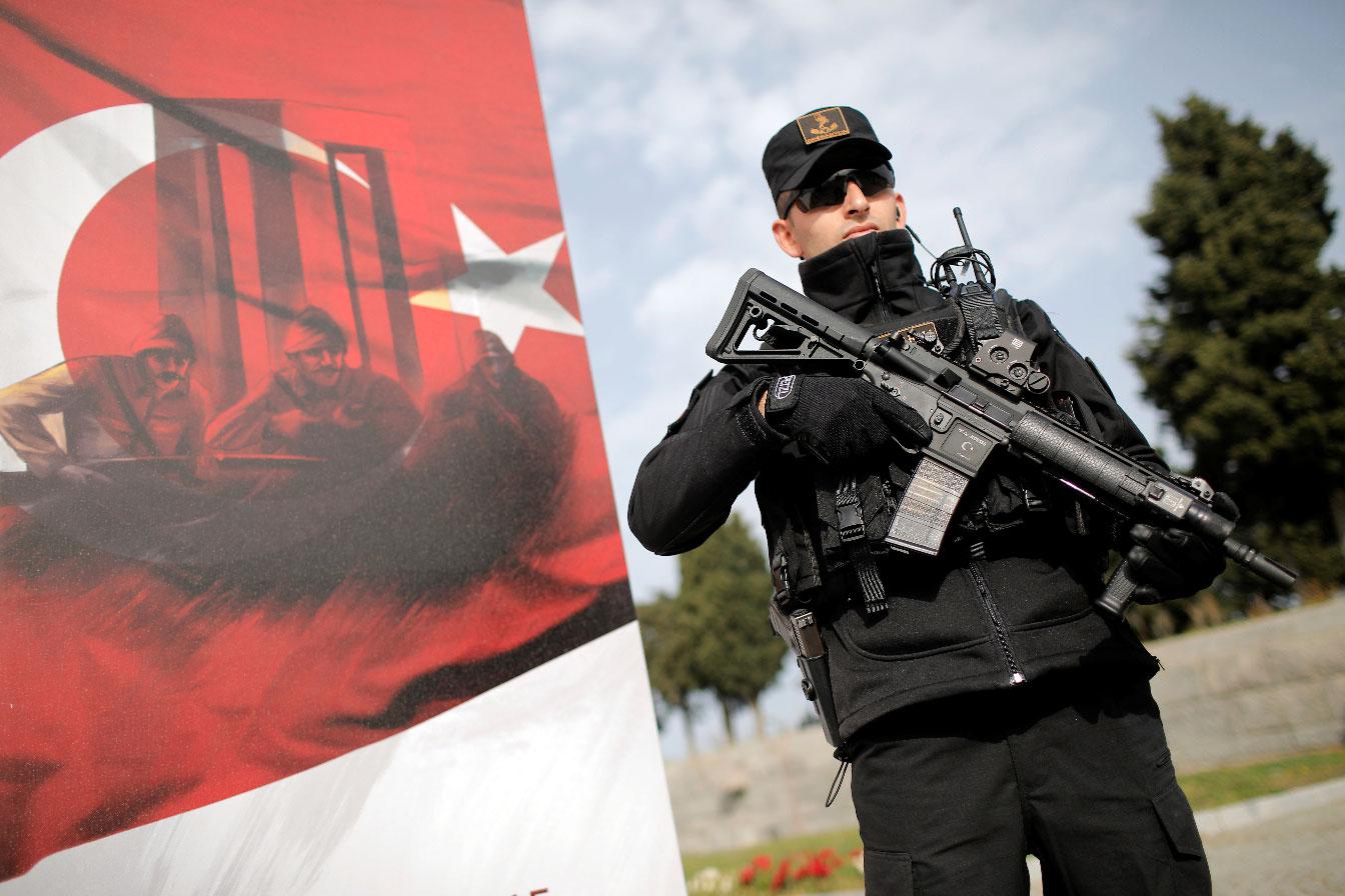 A Turkish gendarme stands guard during an international service marking the 104th anniversary of the WWI battle of Gallipoli at the Turkish memorial in the Gallipoli peninsula in Canakkale