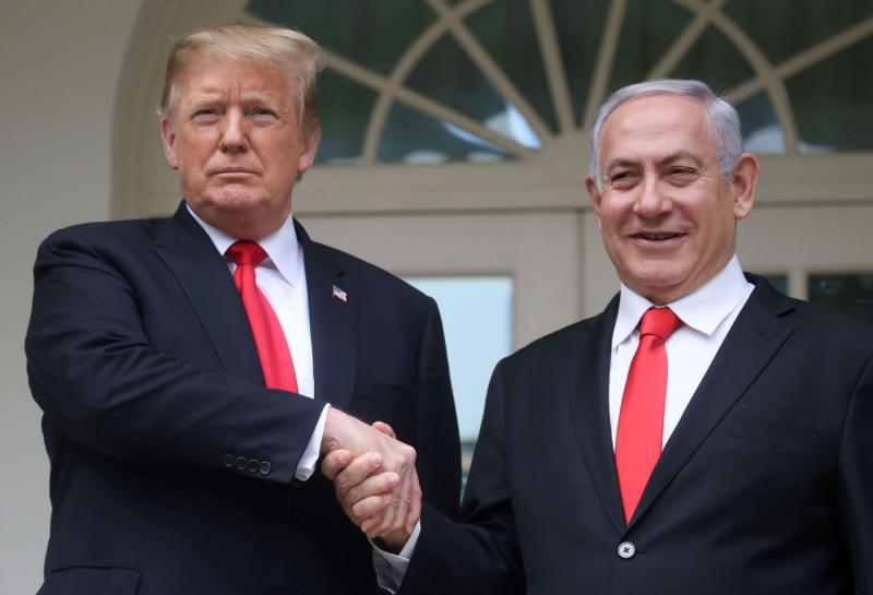 US President Donald Trump shakes hands with Israel's Prime Minister Benjamin Netanyahu as they pose on the West Wing colonnade in the Rose Garden at the White House