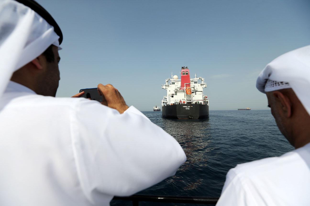 Port officials take a photo of the damaged tanker Andrea Victory at the Port of Fujairah