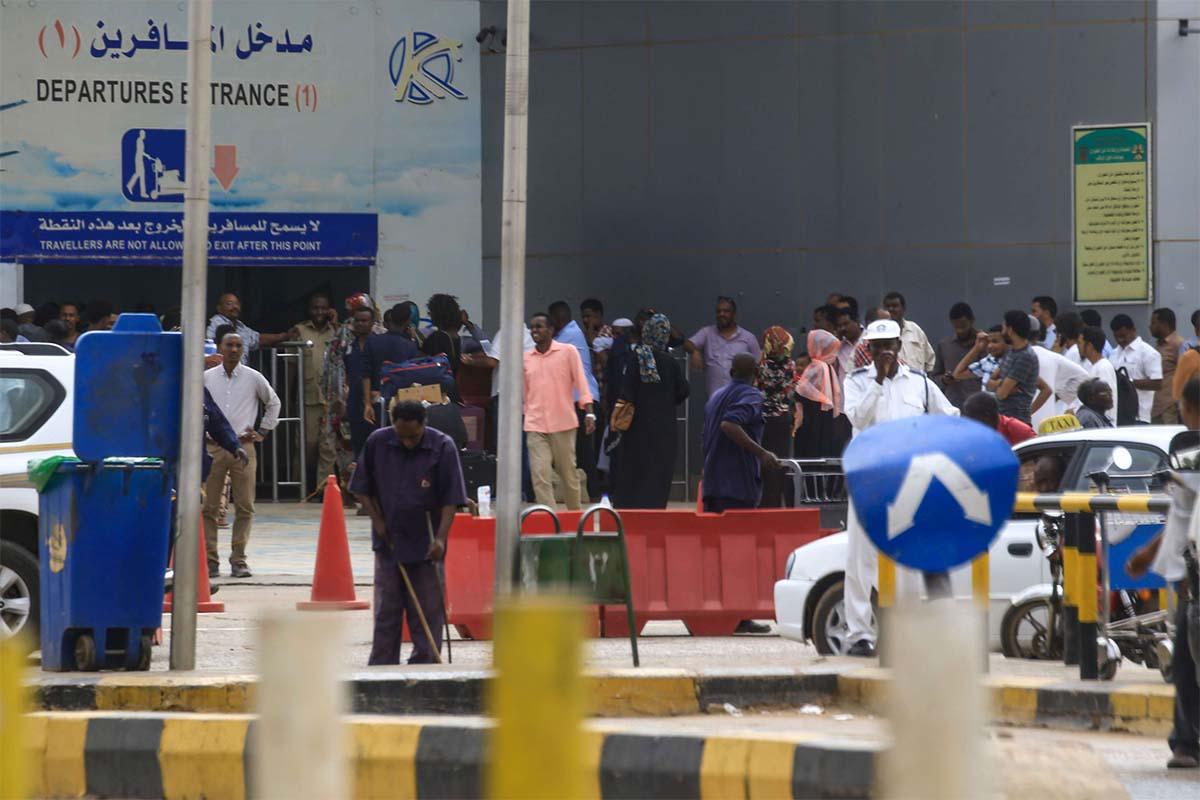 Passengers stranded outside the departure terminal at Khartoum airport