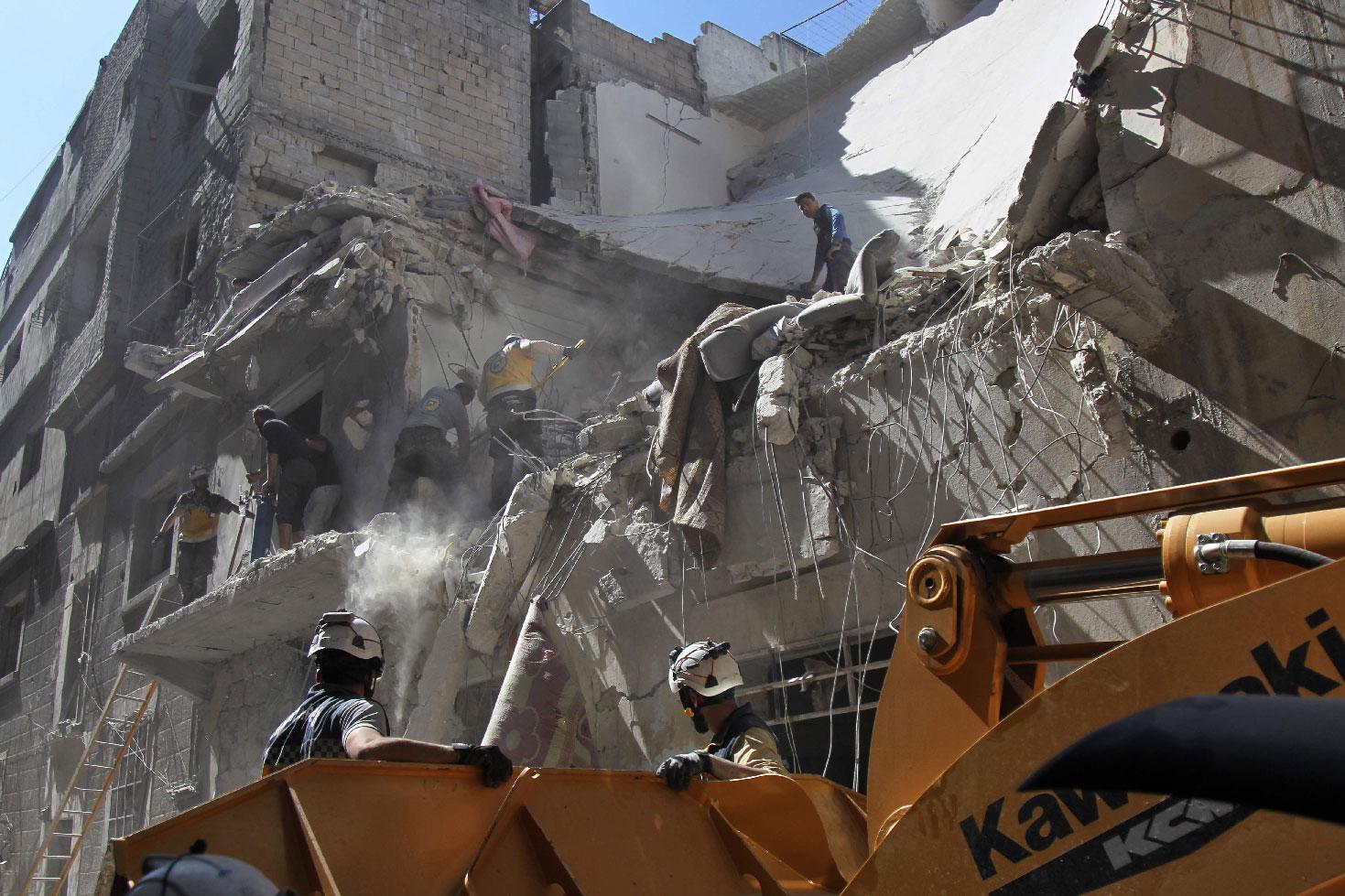 White helmet rescue volunteers and civilians search for survivors amidst the rubble of a building