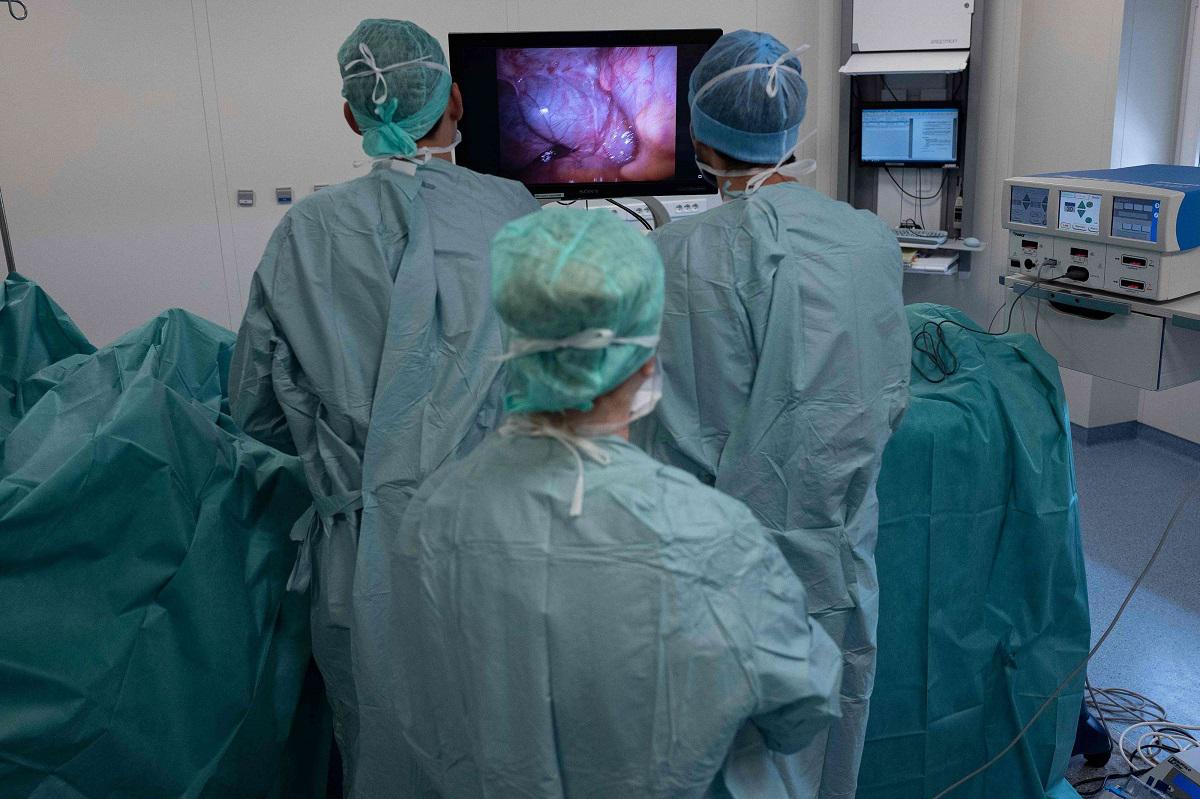 جراحون فرنسيون ينظرون إلى صورة على الشاشة لمعدة مريض مصاب بالسرطان