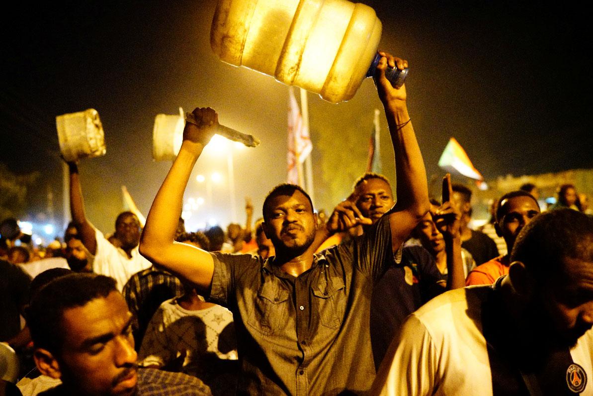 Sudanese people chant slogans during a demonstration in Khartoum