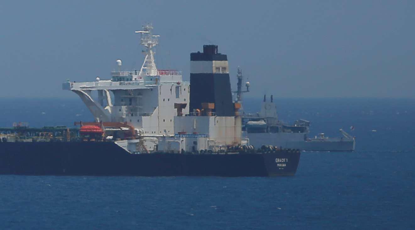 A British Royal Navy patrol vessel guards the oil supertanker Grace 1