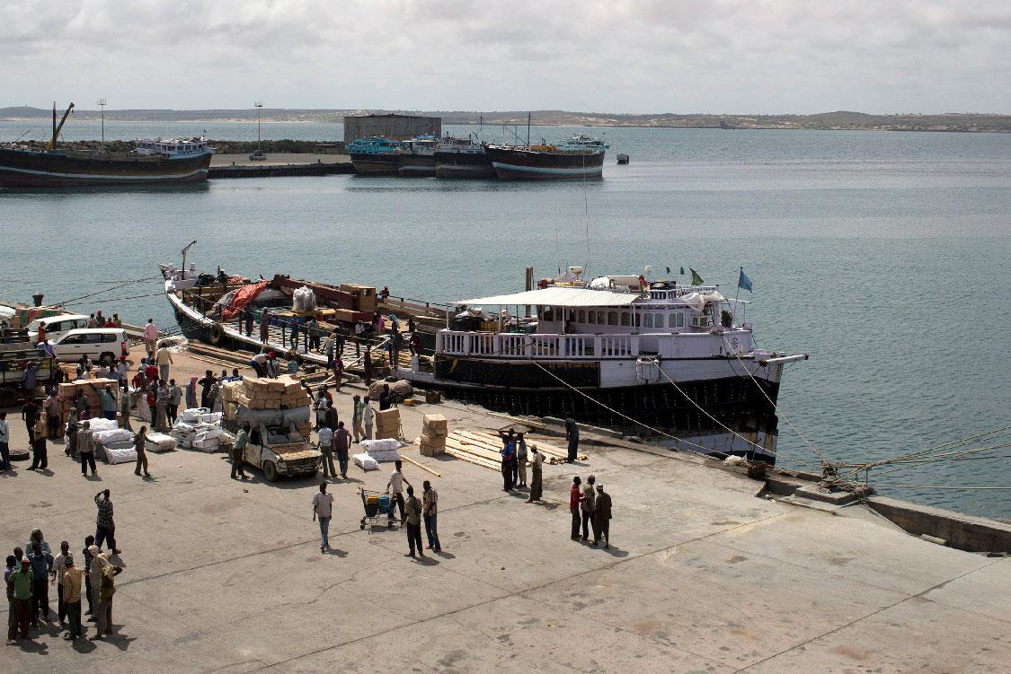  Workers stand at the sea port of the coastal town of Kismayo