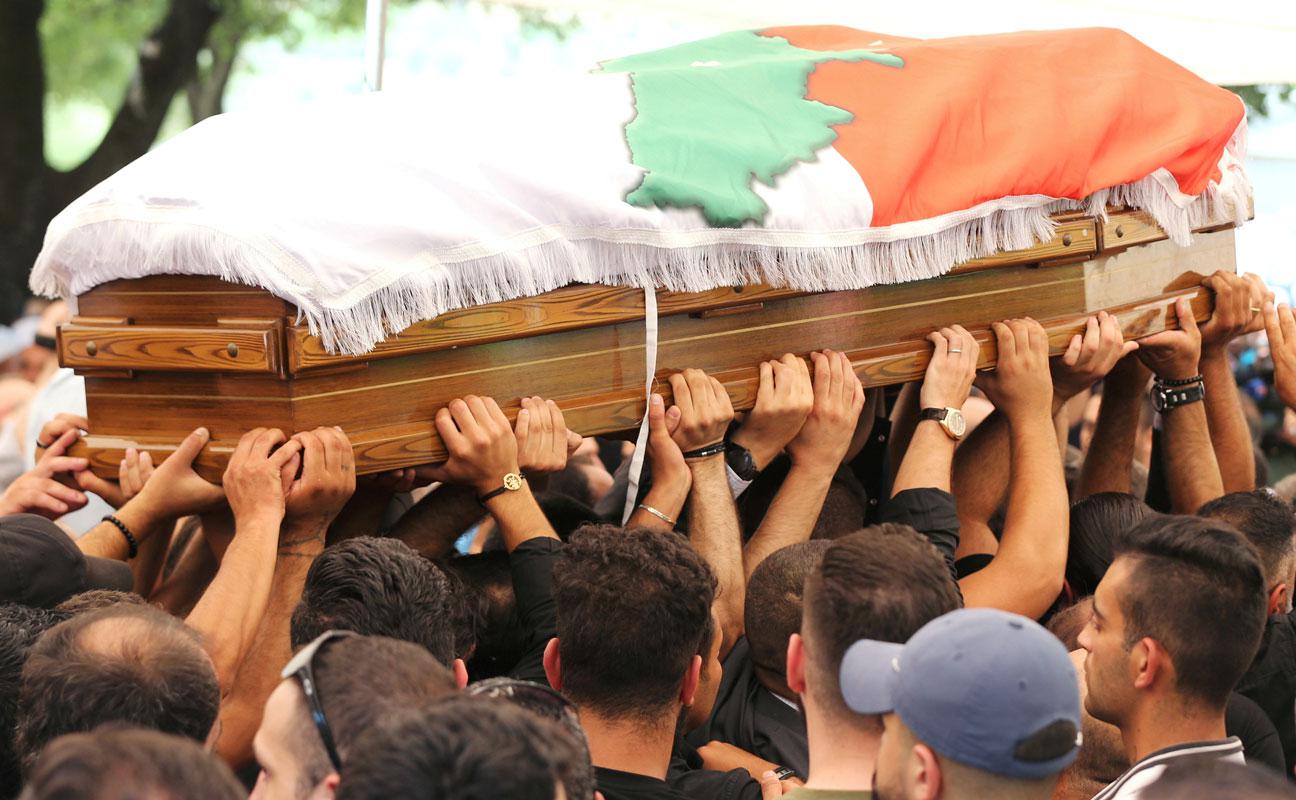 People carry the coffin of Rami Salman, one of two aides of Refugee Affairs Minister Saleh al-Gharib who was killed