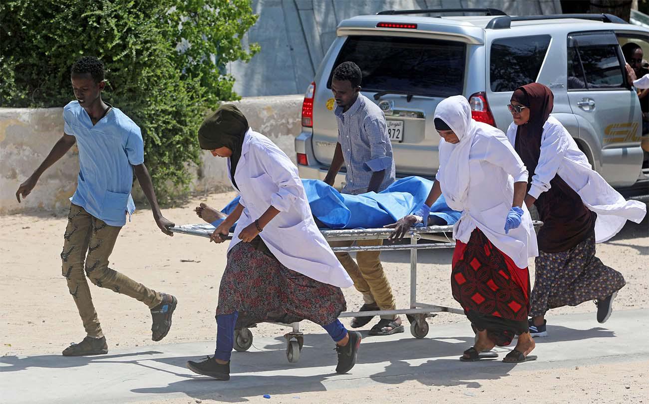 Nurses at the Medina hospital assist a civilian wounded in an explosion outside a hotel near the international airport in Mogadishu