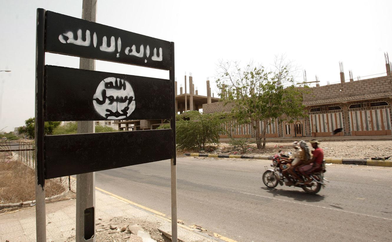 An al-Qaeda logo is seen on a street sign in the town of Jaar in southern Abyan province, Yemen
