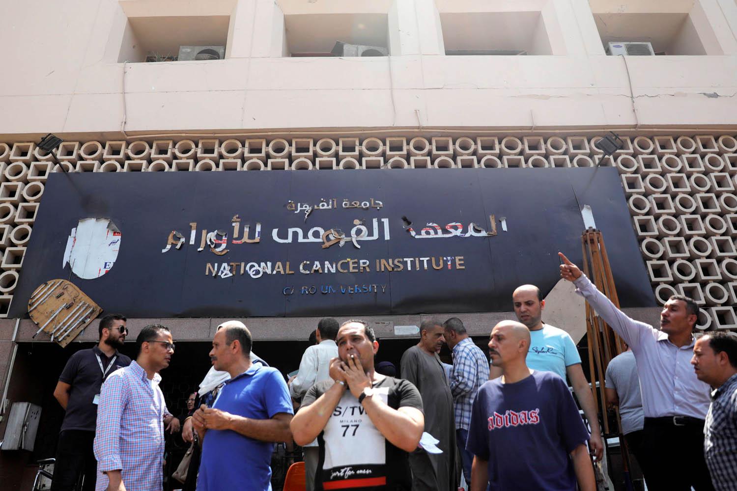 مصريون يقفون أمام معهد الأورام الذي استهدف بهجوم ارهابي