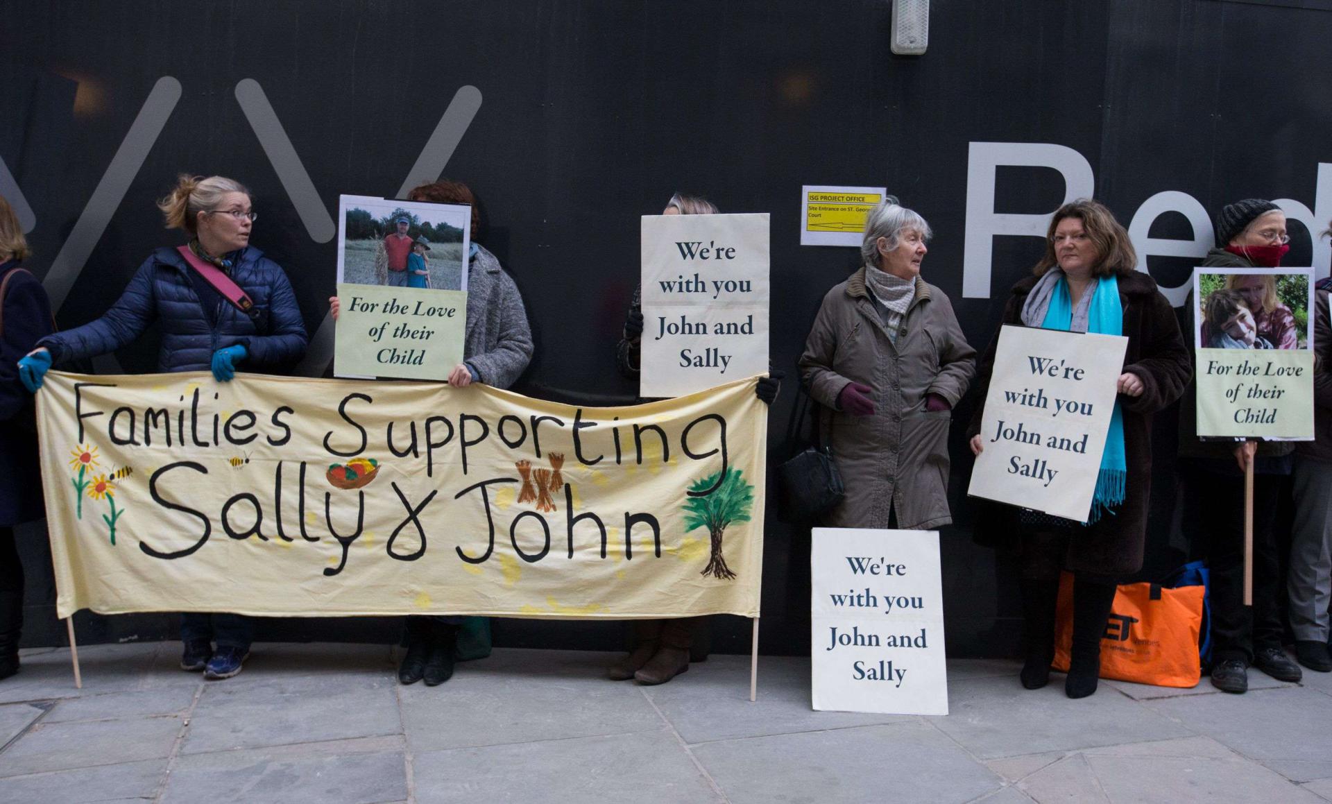 Supporters of John Letts and Sally Lane, parents of Jack Letts who is believed to have left the UK to join Islamic State (IS) hold banners outside the Old Bailey in central London