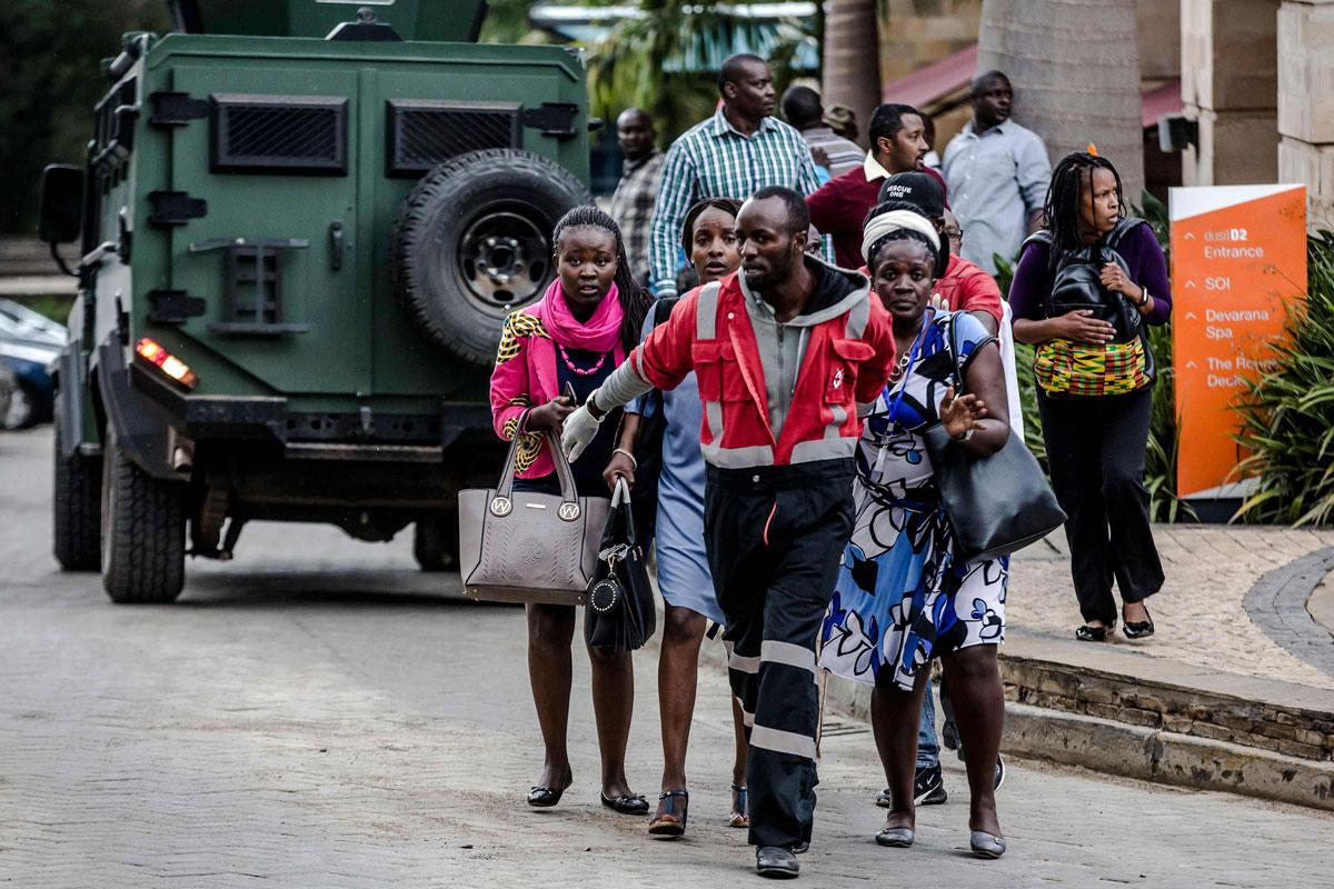 People leave a hotel complex following an explosion in Nairobi's Westlands suburb on January 15