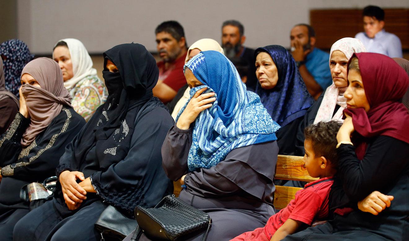 Libyans attend a meeting with charity workers at a gym in the capital Tripoli