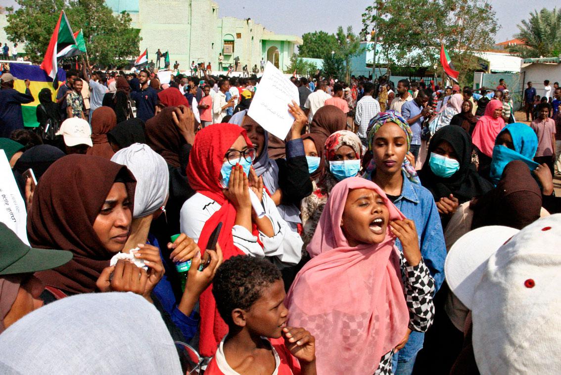 Sudanese protesters chant slogans as they take part in a demonstration called for by the Sudanese Professionals Association