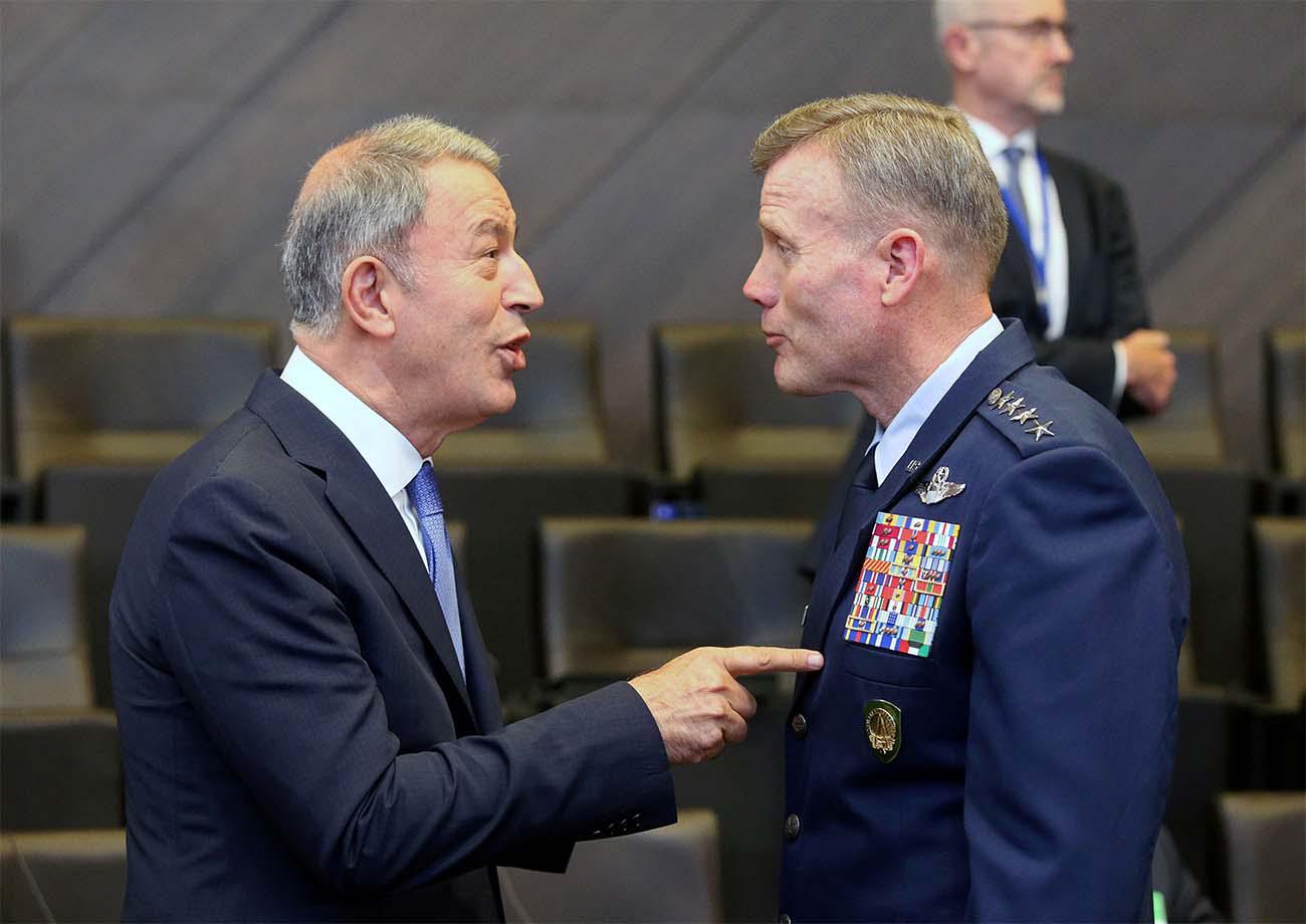Turkish Defence Minister Hulusi Akar (L) speaks with the Supreme Allied Commander Europe, US Air Force General Tod Wolters,