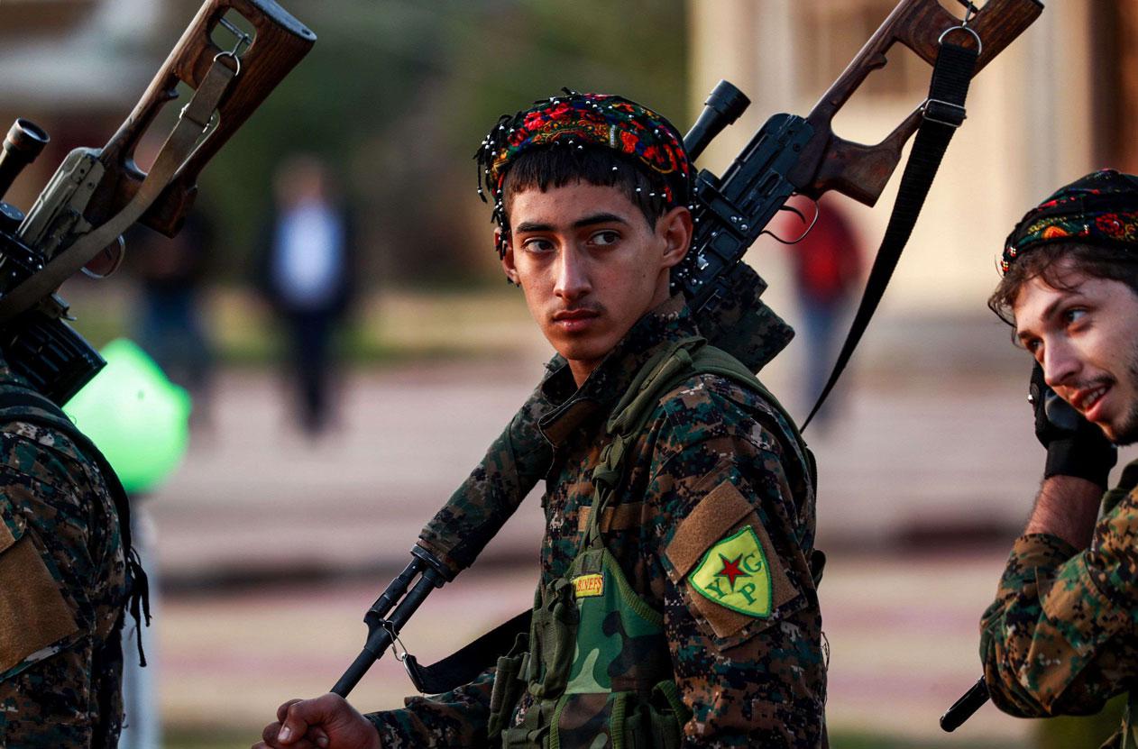 A YPG fighter holds a sniper rifle on his shoulder