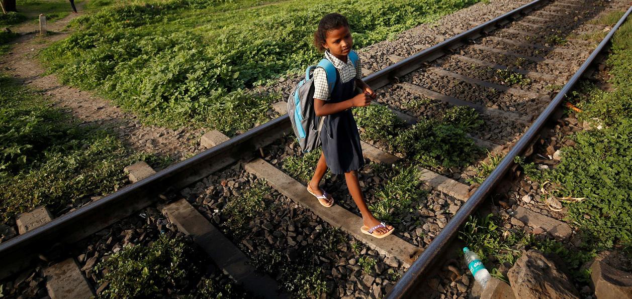 طفلة هندية تعبر سكة القطار خلال ذهابها الى المدرسة