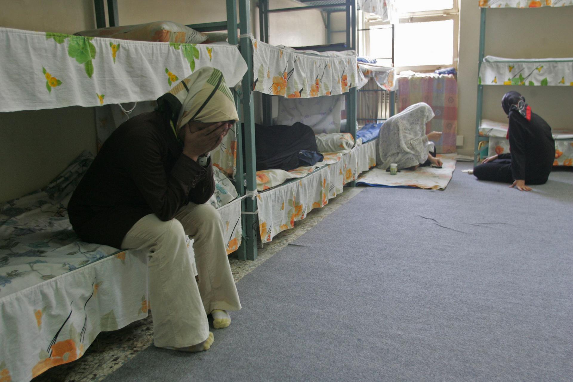 Iranian female prisoners sit in their cells at Evin jail near Tehran
