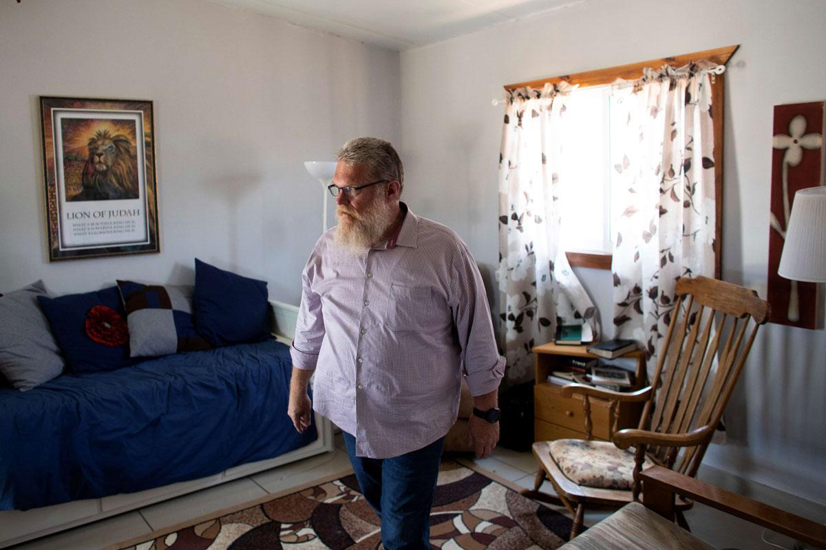 Tommy Waller, founder of US based Christian group HaYovel, walks inside his family's lodgings at the outskirts of Har Bracha settlement in the Israeli-occupied West Bank
