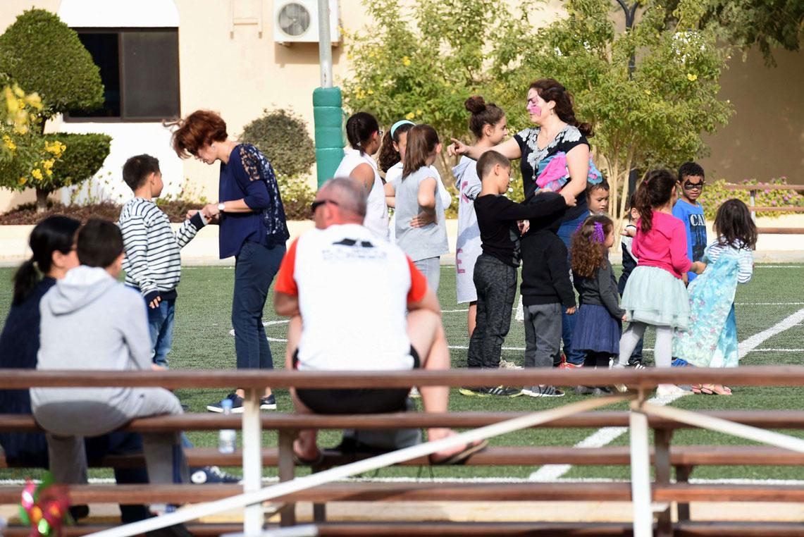 Western expatriates participate in leisure activities with their children in a compound in Riyadh