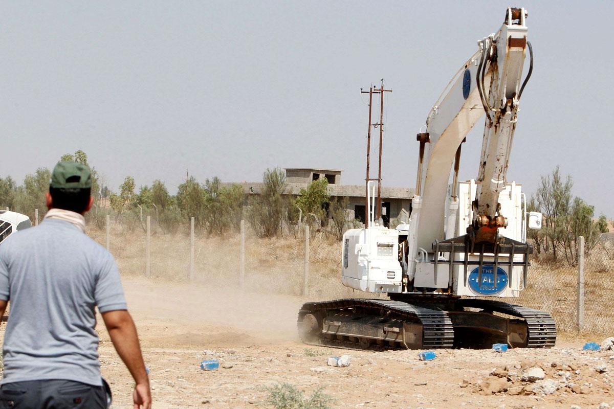 Iraqi mine clearers working with Halo Trust scan an industrial area near Iraq s Baiji