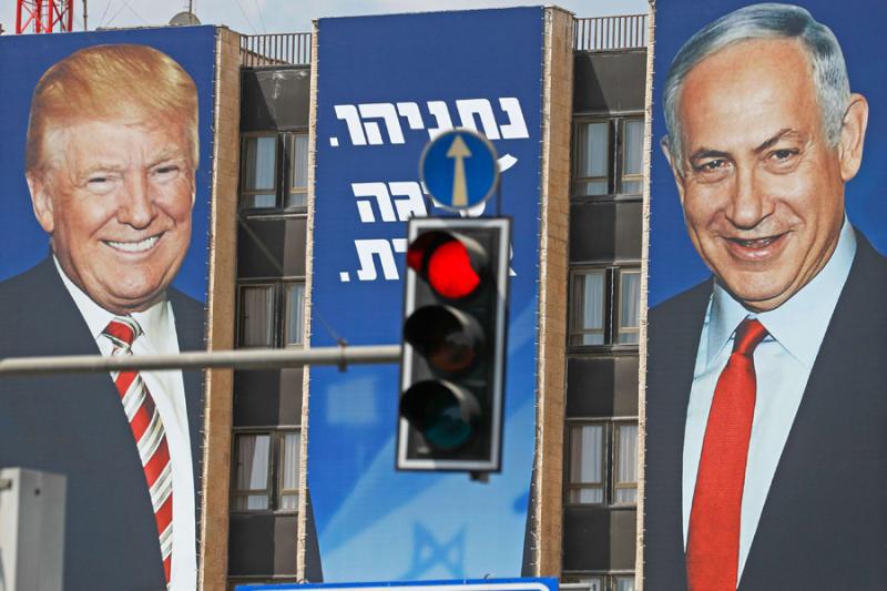 An Israeli election banner depicts US President Donald Trump (L) and Israeli Prime Minister Benjamin Netanyahu hanging on the facade of a building in occupied Jerusalem